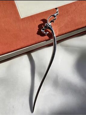 Elegant hair stick in a silvery scroll to elevate updo styles